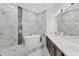 Bathroom showcasing a soaking tub, a frameless shower, and double sinks with granite countertops at 8261 Miramar Way # 8261, Lakewood Ranch, FL 34202