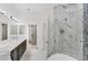 Stylish bathroom with a double vanity, marble shower, and a free-standing tub at 8261 Miramar Way # 8261, Lakewood Ranch, FL 34202