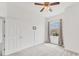 Bedroom features neutral carpeting, a ceiling fan, and a large window view at 8261 Miramar Way # 8261, Lakewood Ranch, FL 34202