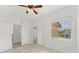 Light-filled room with a tiled floor, big window, and closet space enhanced by a ceiling fan at 8261 Miramar Way # 8261, Lakewood Ranch, FL 34202