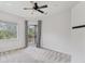 Bright bedroom with a ceiling fan, balcony access and a large window with a great view at 8261 Miramar Way # 8261, Lakewood Ranch, FL 34202