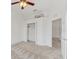 Bright bedroom featuring neutral carpet, ceiling fan, and a closet for ample storage at 8261 Miramar Way # 8261, Lakewood Ranch, FL 34202