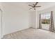 Well-lit room with a large window and neutral walls, highlighted by a ceiling fan at 8261 Miramar Way # 8261, Lakewood Ranch, FL 34202