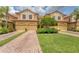 Beautiful townhomes with brick driveways and landscaping offer inviting curb appeal at 8261 Miramar Way # 8261, Lakewood Ranch, FL 34202