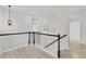Upstairs hallway with dark wood banister, wood floors, and bright natural light at 8261 Miramar Way # 8261, Lakewood Ranch, FL 34202