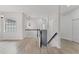 Bright upstairs hallway featuring wood floors, a staircase, and an abundance of natural light at 8261 Miramar Way # 8261, Lakewood Ranch, FL 34202
