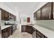 Open kitchen with stainless steel appliances, a breakfast bar, and wood floors at 8261 Miramar Way # 8261, Lakewood Ranch, FL 34202