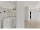 Functional laundry area with a washer and dryer, practical shelving, and lots of storage space at 8261 Miramar Way # 8261, Lakewood Ranch, FL 34202