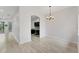 Open area with wood-look floors leading to kitchen with stainless appliances at 8261 Miramar Way # 8261, Lakewood Ranch, FL 34202