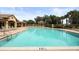 Community pool with ample seating, lounge chairs, a cabana, and easy access to the clubhouse at 8261 Miramar Way # 8261, Lakewood Ranch, FL 34202