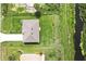 Aerial view of a home featuring a well-manicured lawn, concrete driveway, and a roof in good condition at 8429 Malcolm Ave, North Port, FL 34287