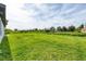 Expansive backyard showcasing lush green grass and views of neighboring properties at 8429 Malcolm Ave, North Port, FL 34287