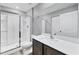 Bathroom features a modern sink, spacious shower with glass door, and gray walls at 8429 Malcolm Ave, North Port, FL 34287