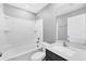 Bathroom with tub and shower combination, modern sink, and sleek gray walls at 8429 Malcolm Ave, North Port, FL 34287