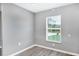 Bedroom featuring neutral walls, base molding, and a window with natural light at 8429 Malcolm Ave, North Port, FL 34287