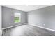 Bedroom featuring neutral walls, wood look flooring, and a window with natural light at 8429 Malcolm Ave, North Port, FL 34287