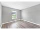 Bedroom featuring gray walls, vinyl floors, a window with a view, and modern trim at 8429 Malcolm Ave, North Port, FL 34287