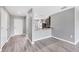 View of the entryway and kitchen featuring wood-look floors and stainless appliances at 8429 Malcolm Ave, North Port, FL 34287