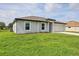 Single-story home boasts a well-kept lawn and a concrete driveway leading to an attached garage at 8429 Malcolm Ave, North Port, FL 34287