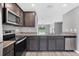 Open kitchen with stainless steel appliances, granite countertops, and wood look floors at 8429 Malcolm Ave, North Port, FL 34287