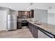 Kitchen with stainless steel appliances, granite counters, and dark wood cabinetry at 8429 Malcolm Ave, North Port, FL 34287