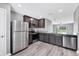 Stylish kitchen with stainless appliances, granite countertops, and wood look flooring at 8429 Malcolm Ave, North Port, FL 34287