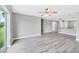 Open-concept living room with grey walls and wood-look floors with abundant natural light at 8429 Malcolm Ave, North Port, FL 34287