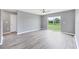 Bright living room with modern floors, ceiling fan and sliding glass door at 8429 Malcolm Ave, North Port, FL 34287