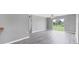 Spacious living room featuring grey walls, wood-look flooring and sliding glass doors at 8429 Malcolm Ave, North Port, FL 34287