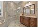 Bathroom featuring walk-in shower, beautiful vanity, and granite countertops at 8445 Lone Eagle Way, Sarasota, FL 34241