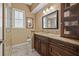 Bathroom featuring dark wood cabinetry, granite countertops, and a glass-enclosed shower at 8445 Lone Eagle Way, Sarasota, FL 34241