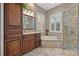 Luxurious bathroom featuring a soaking tub, walk-in shower, and dual vanities at 8445 Lone Eagle Way, Sarasota, FL 34241