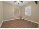 Neutral bedroom with hardwood floors, and plantation shutters allowing lots of natural light at 8445 Lone Eagle Way, Sarasota, FL 34241