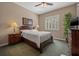 Cozy bedroom with a ceiling fan, shuttered windows, and comfortable furnishings at 8445 Lone Eagle Way, Sarasota, FL 34241