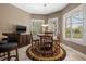 Cozy breakfast nook with a round table, plantation shutters, and lots of natural light at 8445 Lone Eagle Way, Sarasota, FL 34241