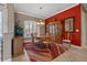 Formal dining area with an area rug, and a hutch with a red accent wall at 8445 Lone Eagle Way, Sarasota, FL 34241