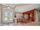 Elegant foyer with decorative glass doors, travertine floors, and adjacent formal dining area at 8445 Lone Eagle Way, Sarasota, FL 34241