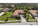 Well-maintained home on a green lawn with mature palm trees and a clean driveway at 8445 Lone Eagle Way, Sarasota, FL 34241