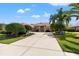 Attractive home showcasing a well-kept lawn, mature trees, and a spacious driveway at 8445 Lone Eagle Way, Sarasota, FL 34241