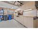 Garage featuring ample storage cabinets and a workbench area for various projects at 8445 Lone Eagle Way, Sarasota, FL 34241