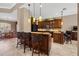 Kitchen featuring dark wood cabinets, granite countertops, stainless appliances, and adjacent dining area with seating at 8445 Lone Eagle Way, Sarasota, FL 34241