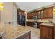 Modern kitchen featuring dark wood cabinets, granite countertops, stainless steel appliances, and ample counter space at 8445 Lone Eagle Way, Sarasota, FL 34241