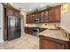 Well-equipped kitchen with stainless steel appliances, granite countertops, dark wood cabinetry, and ample counter space at 8445 Lone Eagle Way, Sarasota, FL 34241