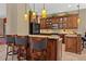 Spacious kitchen featuring a breakfast bar with granite counters and modern appliances at 8445 Lone Eagle Way, Sarasota, FL 34241