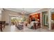 Open-concept living room with view to outdoor lanai, comfortable seating, and seamless access to dining and kitchen at 8445 Lone Eagle Way, Sarasota, FL 34241
