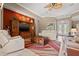 Cozy living room with comfortable seating, a ceiling fan, and a decorative media center at 8445 Lone Eagle Way, Sarasota, FL 34241