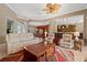 Bright living room with neutral walls, leather furniture, and a view into the dining room with red accent wall at 8445 Lone Eagle Way, Sarasota, FL 34241
