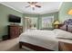 Bright main bedroom featuring a decorative ceiling fan, sliding glass doors and lots of light at 8445 Lone Eagle Way, Sarasota, FL 34241