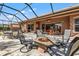 Beautiful screened patio with a fire pit and ample seating for relaxing and entertaining at 8445 Lone Eagle Way, Sarasota, FL 34241