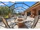 Screened patio with firepit, jacuzzi, outdoor seating and dining; ideal for entertaining at 8445 Lone Eagle Way, Sarasota, FL 34241